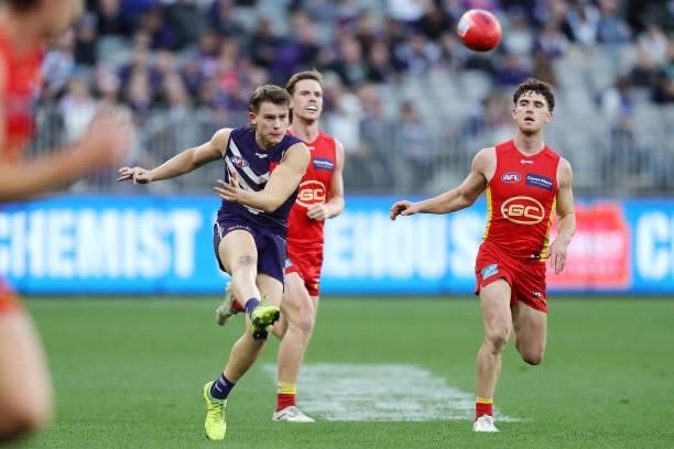 Caleb Serong of the Dockers kicks the ball during the 2021 AFL Round 13 match between the Fremantle Dockers and the Gold Coast Suns at Optus Stadium...