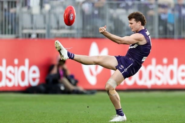 Blake Acres of the Dockers kicks the ball during the 2021 AFL Round 13 match between the Fremantle Dockers and the Gold Coast Suns at Optus Stadium...