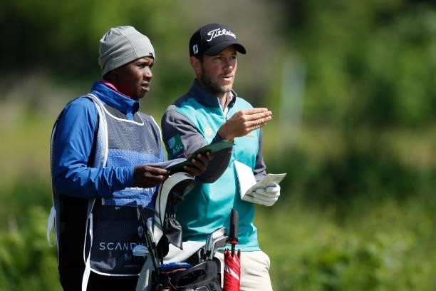 Rhys Enoch of Wales looks on with his caddie during the third round of The Scandinavian Mixed Hosted by Henrik and Annika at Vallda Golf & Country...