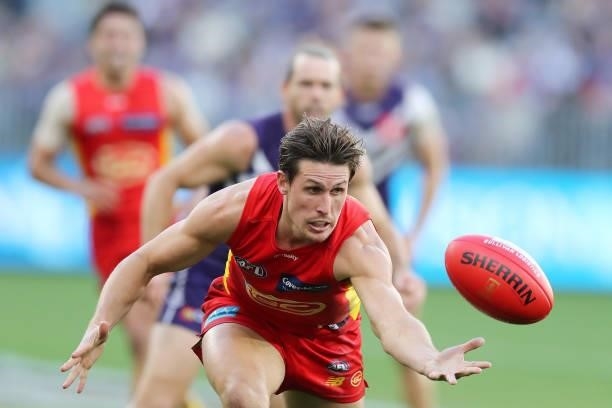 David Swallow of the Suns chases the ball during the 2021 AFL Round 13 match between the Fremantle Dockers and the Gold Coast Suns at Optus Stadium...