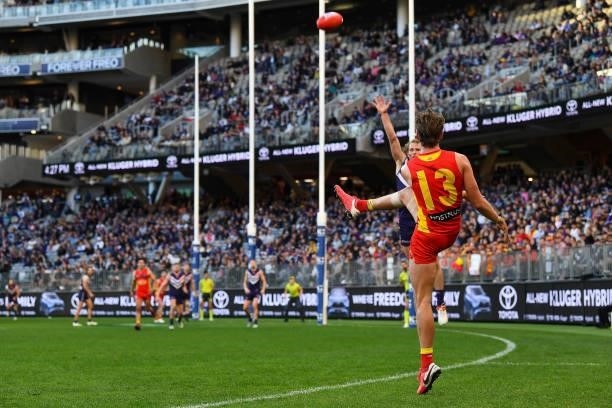 Jack Lukosius of the Suns kicks on goal during the 2021 AFL Round 13 match between the Fremantle Dockers and the Gold Coast Suns at Optus Stadium on...