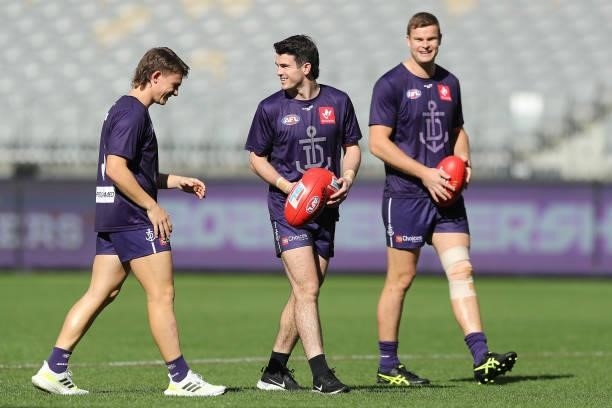 Caleb Serong, Andrew Brayshaw and Sean Darcy of the Dockers walk the pitch during the 2021 AFL Round 13 match between the Fremantle Dockers and the...