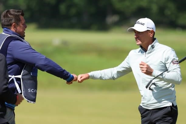 Jason Scrivener of Australia reacts with caddie on the 9th hole during the third round of The Scandinavian Mixed Hosted by Henrik and Annika at...