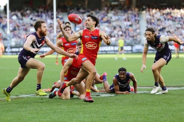 Izak Rankine of the Suns controls the ball during the 2021 AFL Round 13 match between the Fremantle Dockers and the Gold Coast Suns at Optus Stadium...