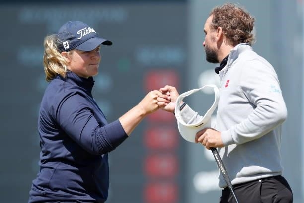Caroline Hedwall of Sweden and Joost Luiten of the Netherlands fist bump on the 18th green during the third round of The Scandinavian Mixed Hosted by...