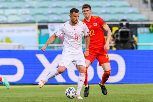 Haris Seferovic of Switzerland passes the ball during the UEFA Euro 2020 Championship Group A match between Wales and Switzerland on June 12, 2021 in...