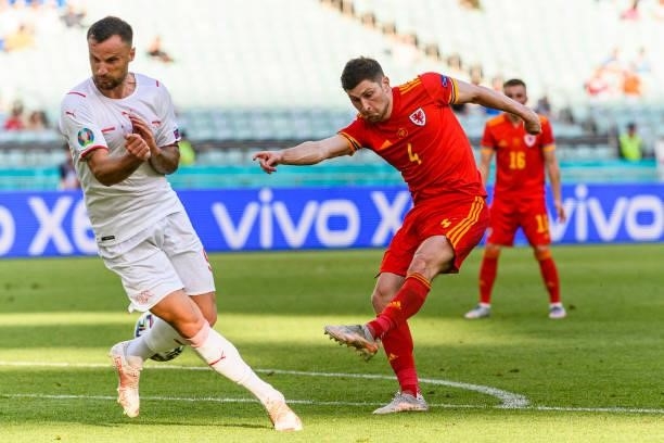 Ben Davies of Wales attempts a kick while being defended by Haris Seferovic of Switzerland during the UEFA Euro 2020 Championship Group A match...