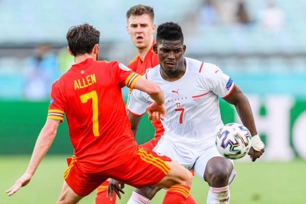Breel Embolo of Switzerland fights for the ball with Joe Allen of Wales during the UEFA Euro 2020 Championship Group A match between Wales and...