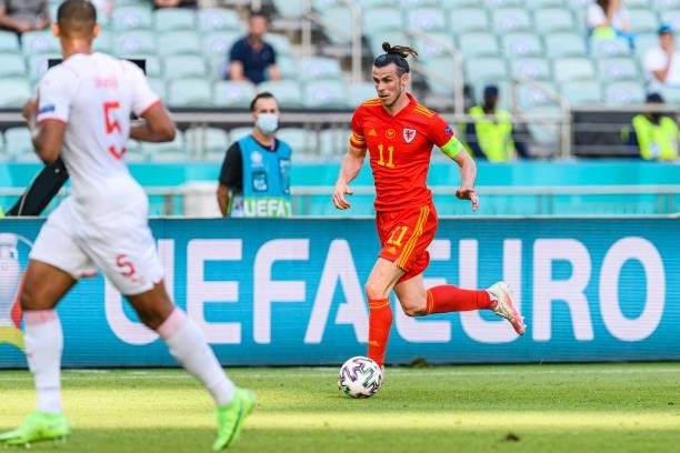 Gareth Bale of Wales runs with the ball during the UEFA Euro 2020 Championship Group A match between Wales and Switzerland on June 12, 2021 in Baku,...