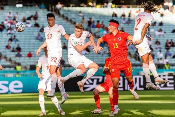 Kieffer Moore of Wales fights for the ball with Kevin Mbabu of Switzerland during the UEFA Euro 2020 Championship Group A match between Wales and...
