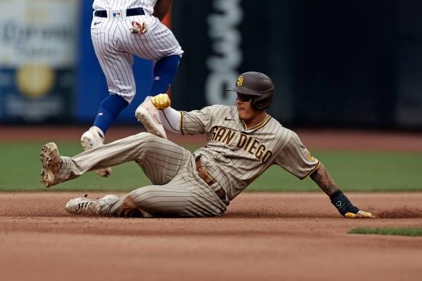 Manny Machado of the San Diego Padres is out sliding under Francisco Lindor of the New York Mets during the fourth inning at Citi Field on June 12,...