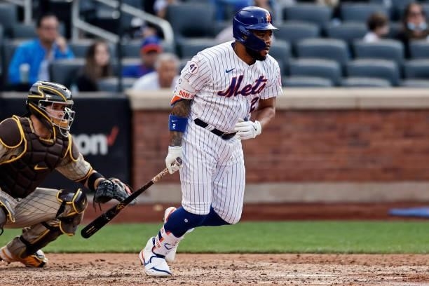 Dominic Smith of the New York Mets hits into a fielders choice to score a run during the sixth inning against the San Diego Padres at Citi Field on...