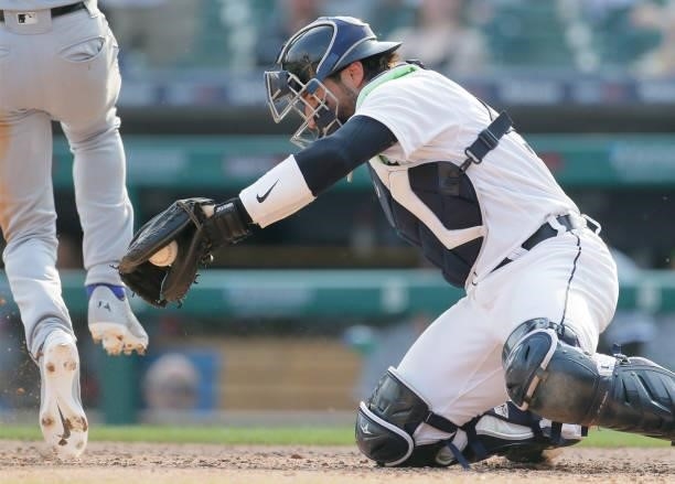 Catcher Eric Haase of the Detroit Tigers can't make the tag on Tim Anderson of the Chicago White Sox during the fifth inning at Comerica Park on June...