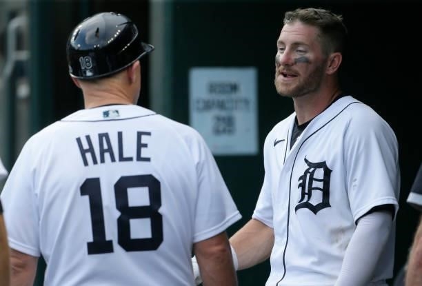 Robbie Grossman of the Detroit Tigers talks with third base coach Chip Hale during the eighth inning of a game against the Chicago White Sox at...
