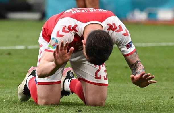 Denmark's midfielder Pierre Hojbjerg reacts after missing a penalty shot during the UEFA EURO 2020 Group B football match between Denmark and Finland...