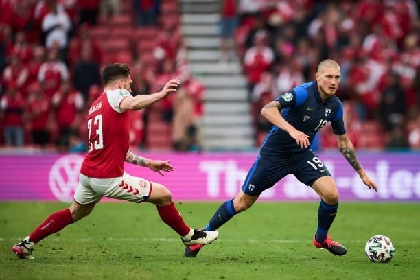 Pierre-Emile Hojbjerg of Denmark and Joni Kauko of Finland compete for the ball during the UEFA EURO 2020 Group B match between Denmark and Finland...
