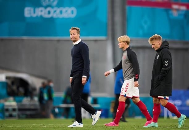 Kasper Hjulmand, head coach of Denmark, Kasper Dolberg and Daniel Wass of Denmark leaving the pitch after the UEFA EURO 2020 Group B match between...