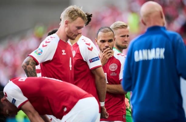 Simon Kjar, Martin Braithwaite and Kasper Schmeichel of Denmark showing emotions watching the medical treatment of Christian Eriksen during the UEFA...