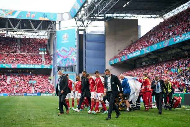 Christian Eriksen of Denmark is taking away from the pitch for medical treatment during the UEFA EURO 2020 Group B match between Denmark and Finland...