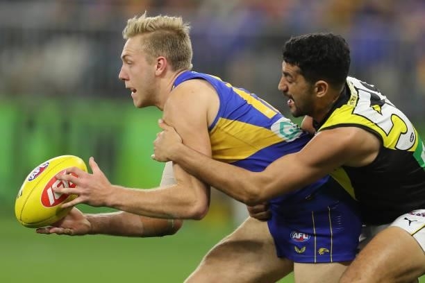 Oscar Allen of the Eagles is tackled by Marlion Pickett of the Tigers during the 2021 AFL Round 13 match between the West Coast Eagles and the...