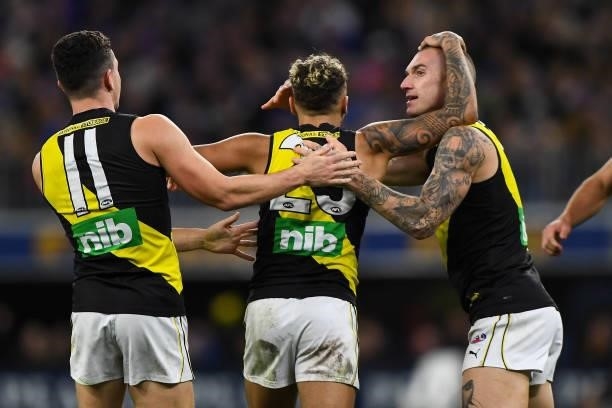 Jason Castagna, Shai Bolton and Dustin Martin of the Tigers celebrates a goal during the 2021 AFL Round 13 match between the West Coast Eagles and...