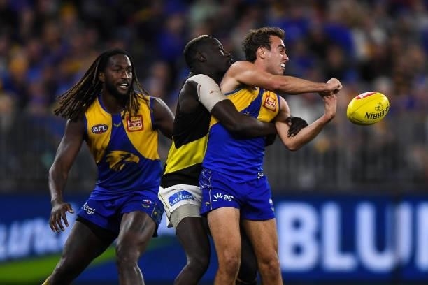 Luke Edwards of the Eagles handpasses the ball during the 2021 AFL Round 13 match between the West Coast Eagles and the Richmond Tigers at Optus...