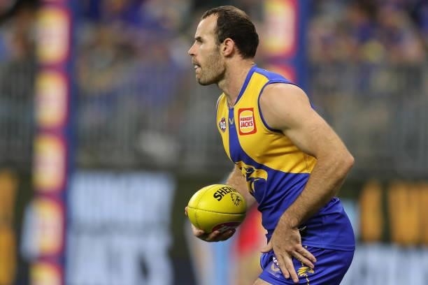Shannon Hurn of the Eagles looks to pass the ball during the 2021 AFL Round 13 match between the West Coast Eagles and the Richmond Tigers at Optus...