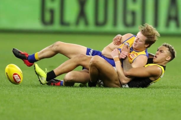 Jackson Nelson of the Eagles is tackled by Shai Bolton of the Tigers during the 2021 AFL Round 13 match between the West Coast Eagles and the...