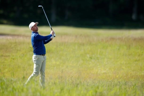 Jonathan Caldwell of Northern Ireland hits his second shot on the 18th hole during the final round of The Scandinavian Mixed Hosted by Henrik and...