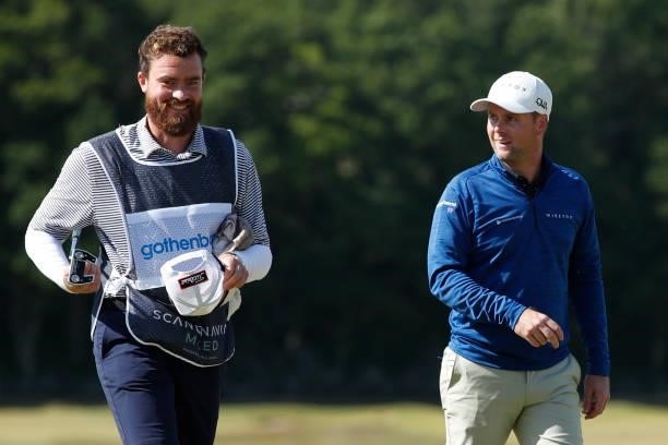 Jonathan Caldwell of Northern Ireland walks off the 18th green with his caddie during the final round of The Scandinavian Mixed Hosted by Henrik and...