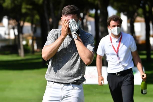 Kristof Ulenaers of Belgium is soaked with champagne after holing the winning putt on the 18th green during the final round of the Challenge de Cadiz...