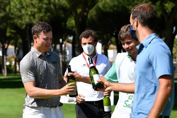 Kristof Ulenaers of Belgium celebrates with champagne after holing the winning putt on the 18th green during the final round of the Challenge de...