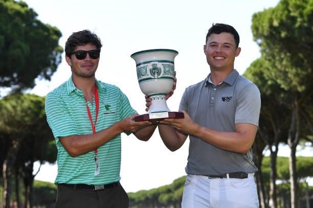 Kristof Ulenaers of Belgium poses with the trophy and his caddie after his win during the final round of the Challenge de Cadiz at Iberostar Real...
