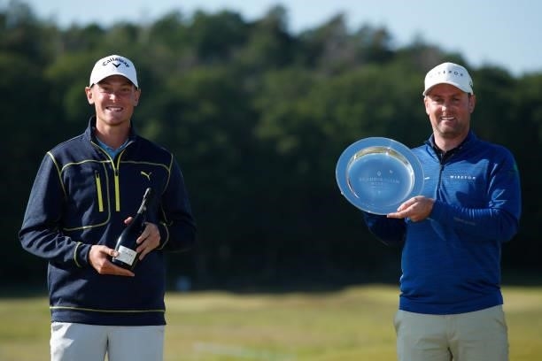 Leading Amateur Vincent Norrman of Sweden poses with Jonathan Caldwell of Northern Ireland and the trophy during the final round of The Scandinavian...