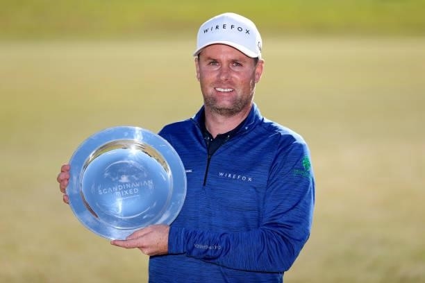 Jonathan Caldwell of Northern Ireland poses with the trophy after his win during the final round of The Scandinavian Mixed Hosted by Henrik and...