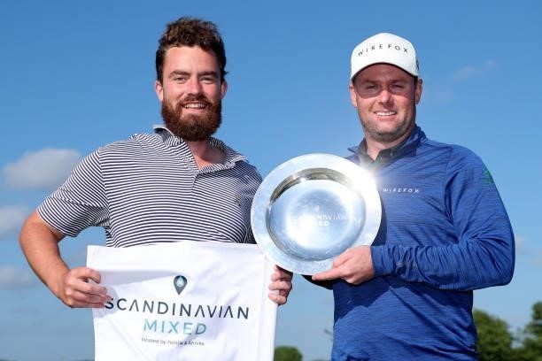 Jonathan Caldwell of Northern Ireland poses with the trophy and his caddie after his win during the final round of The Scandinavian Mixed Hosted by...