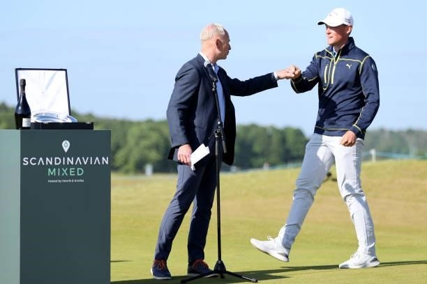 Mikael Eriksson congratulates low Amateur Vincent Norrman of Sweden at the trophy presentation during the final round of The Scandinavian Mixed...
