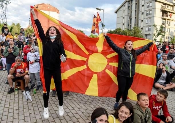 Supporters react with a flag of North Macedonia as they watch the UEFA EURO 2020 Group C football match between Austria and North Macedonia in...