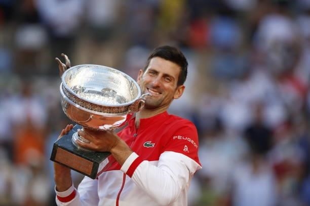 Winner Novak Djokovic of Serbia poses with trophy after defeating Stefanos Tsitsipas of Greece during their Men's final match at the French Open...