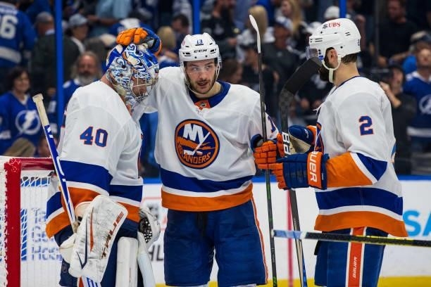 Goalie Semyon Varlamov of the New York Islanders celebrates the win with teammate Mathew Barzal against the Tampa Bay Lightning after Game One of the...