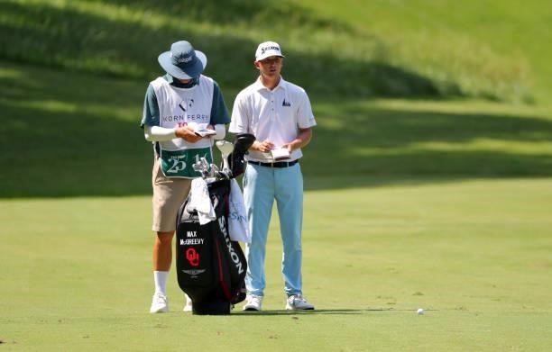Max McGreevy and his caddie stand in the fairway on the eighth hole during the final round of the BMW Charity Pro-Am presented by Synnex Corporation...