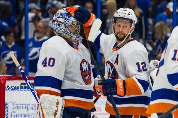 Goalie Semyon Varlamov of the New York Islanders celebrates the win with teammate Josh Bailey against the Tampa Bay Lightning after Game One of the...