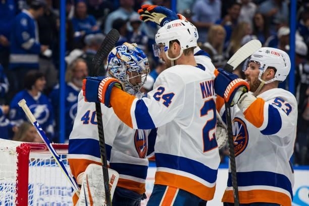 Goalie Semyon Varlamov of the New York Islanders celebrates the win with teammate Scott Mayfield against the Tampa Bay Lightning after Game One of...