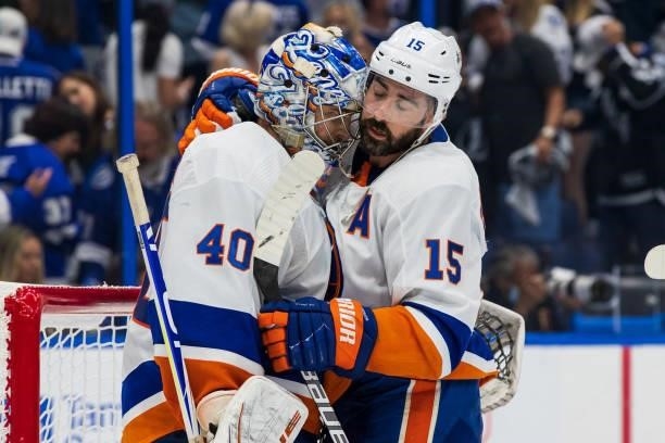 Goalie Semyon Varlamov of the New York Islanders celebrates the win with teammate Cal Clutterbuck against the Tampa Bay Lightning after Game One of...