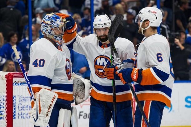 Goalie Semyon Varlamov of the New York Islanders celebrates the win with teammate Nick Leddy against the Tampa Bay Lightning after Game One of the...
