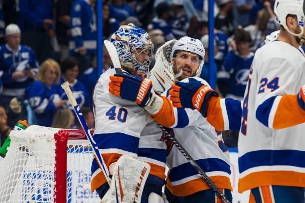 Goalie Semyon Varlamov of the New York Islanders celebrates the win with teammate Casey Cizikas against the Tampa Bay Lightning after Game One of the...