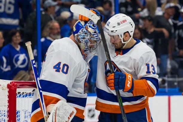 Goalie Semyon Varlamov of the New York Islanders celebrates the win with teammate Mathew Barzal against the Tampa Bay Lightning after Game One of the...