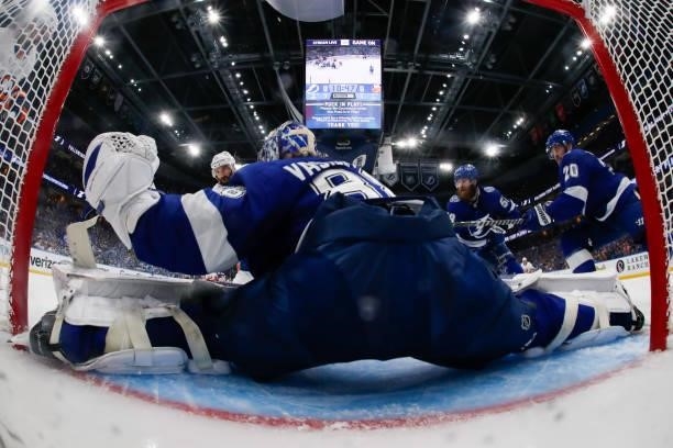 Goalie Andrei Vasilevskiy of the Tampa Bay Lightning stretches to make a save against Kyle Palmieri of the New York Islanders during the first period...