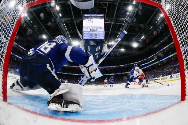 Goalie Andrei Vasilevskiy of the Tampa Bay Lightning stretches to make a save against Mathew Barzal of the New York Islanders during the third period...