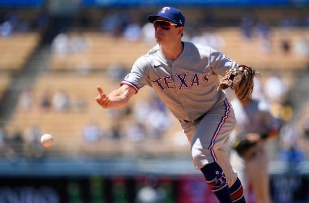 Nick Solak of the Texas Rangers throws late to first base in an attempt to get Brant Brown of the Los Angeles Dodgers during the third inning of a...